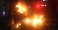 Six arrests after protesters burn police van in Dublin