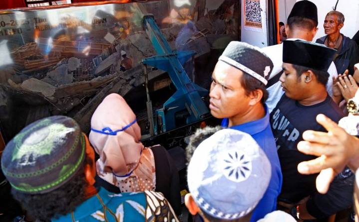 Ambulances line up near collapsed Indonesian school building as search for trapped students continues