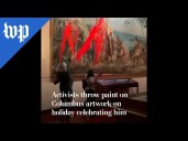 Activists in Spain throw paint on Columbus artwork