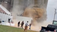 Watch gigantic grain bin collapse, people run for their lives