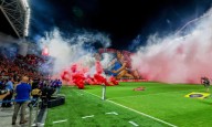Israeli soccer game abandoned after rioting rival fans throw flares and smoke grenades