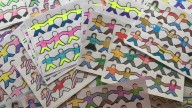 Protesters display paper dolls to challenge benefit reduction for needy families