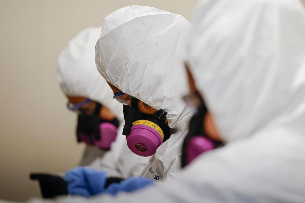 In the fire zones, an immigrant workforce warily carries out cleanups