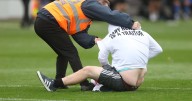 Three arrested as anti-Gary Neville protesters with England flags invade pitch at Salford City