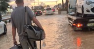 UK tourist wades through muddy floodwater to reach Ibiza Airport after heavy rain