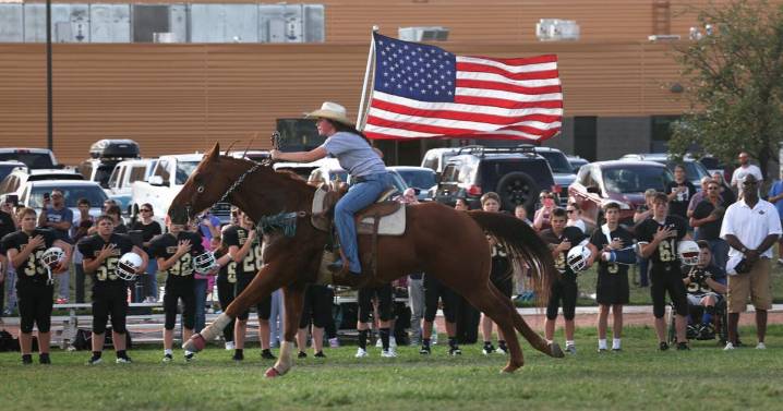 Photo: Medicine Crow 7th grader carries colors during football game