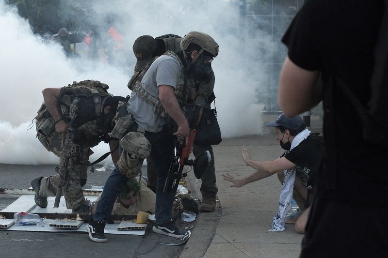 Border Patrol agents shoot armed woman in Chicago as protesters confront immigration personnel