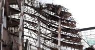 'We thought it was an earthquake': Drama as part of Manchester city centre building collapses during demolition work as debris flung into River Irwell
