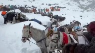 Snowstorms strand hikers in China and a South Korean climber dies in Nepal