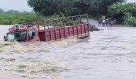 Goods truck washed away along with driver in a stream in Khammam