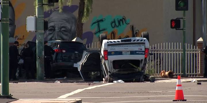 2 officers, 1 other hospitalized after police vehicle rolls over in Phoenix