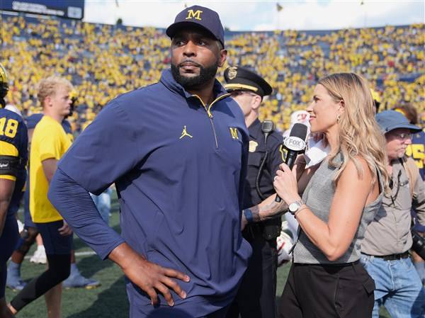 Michigan and coach Moore drop appeal of NCAA penalties from sign