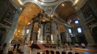 Man disrupts St. Peter's Basilica, climbs altar before security escort