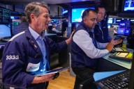 Wall Street rises and pulls close to its record