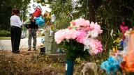 People pay respects at memorial for three E.E. Smith students