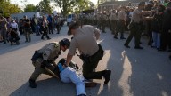 Noem visits Chicago area ICE facility as agents arrest 13, raid city neighborhoods