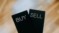 Markets open lower as investors react to Q2 results