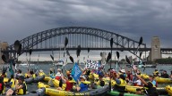 Activists paddle across Sydney Harbour to demand no new coal and gas projects