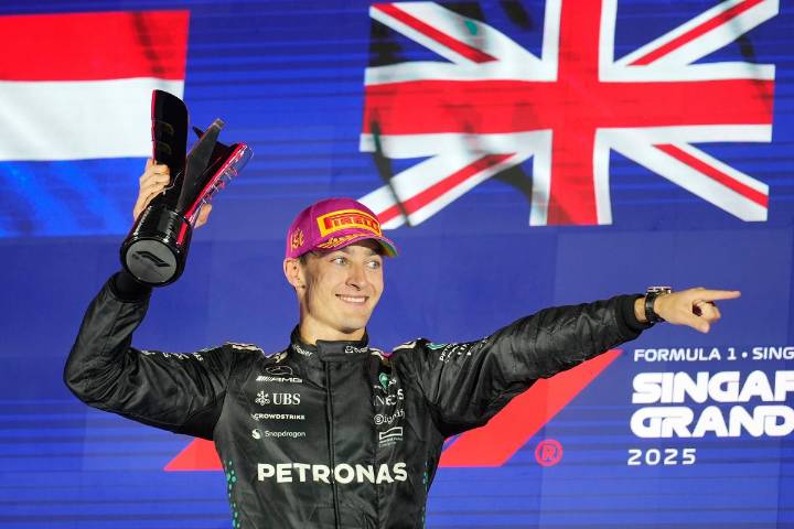 McLaren duo collide on opening lap before George Russell wins Singapore GP