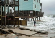 Dozens rescued as remnants of typhoon hits Alaska while nor'easter brings flooding to East Coast