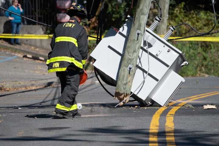 Utility pole containing transformer toppled in Rossville section of Staten Island; hundreds without power