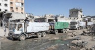 Aid trucks roll into Gaza, Hamas hands over more bodies