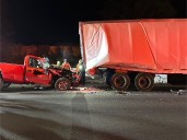 Driver extricated from pickup smashed under tractor