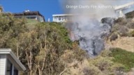 Crews respond to douse fire threatening homes along Pacific Coast Highway