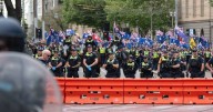Police cop rocks, bottles as migration protesters clash