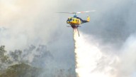 Exclusion zone declared as bushfire sparks major emergency response near Brisbane