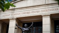 Fired federal prosecutor tapes a note about duty to the door on his way out
