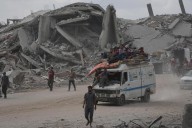The Latest: Palestinians journey back home as aid convoys start to enter Gaza