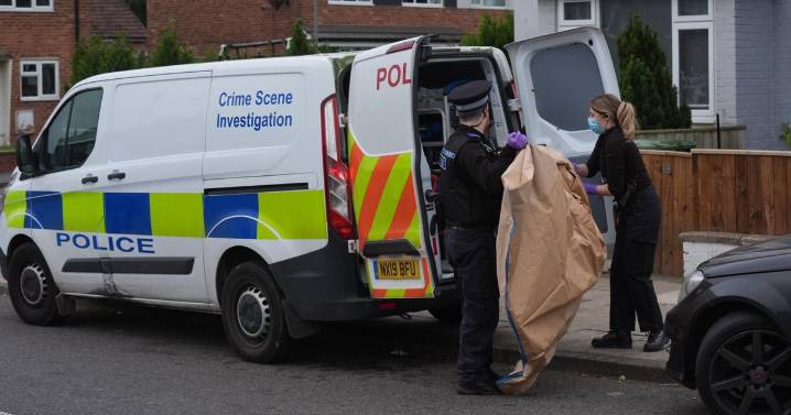 Crime scene investigators at Hardwick house as officers carry out large brown evidence bags