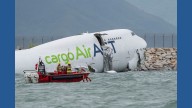 A cargo aircraft skids off a Hong Kong runway into the sea, killing 2 people