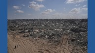 Palestinians return to ruins and US expects hostages freed on Monday as Gaza ceasefire holds