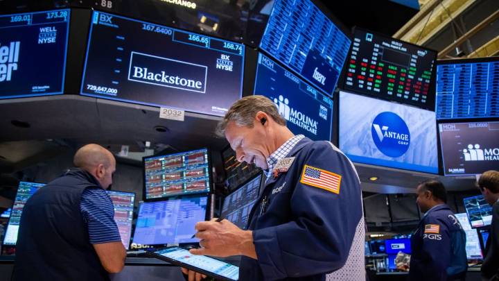 Wall Street notches record closing highs on cool inflation, solid earnings
