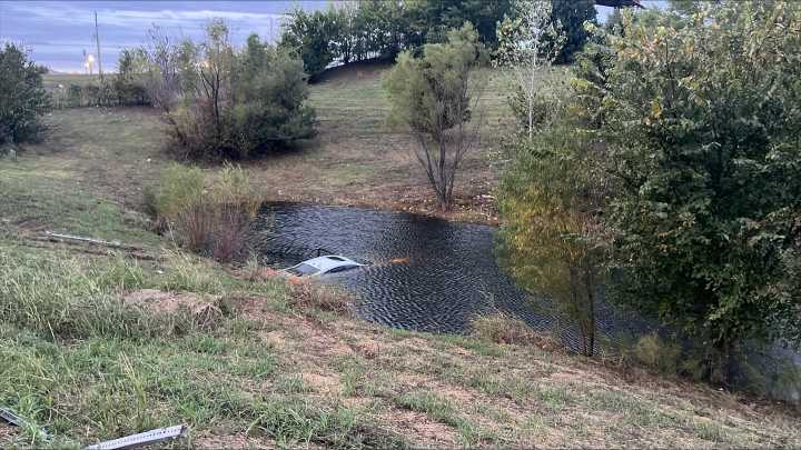 Driver rescued after car submerges in pond near Tulsa Hills