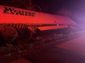 One hospitalized after tractor-trailer rolls over on I