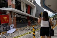 Philippines earthquake: Rescuers search in mud and rubble for survivors as at least 69 killed