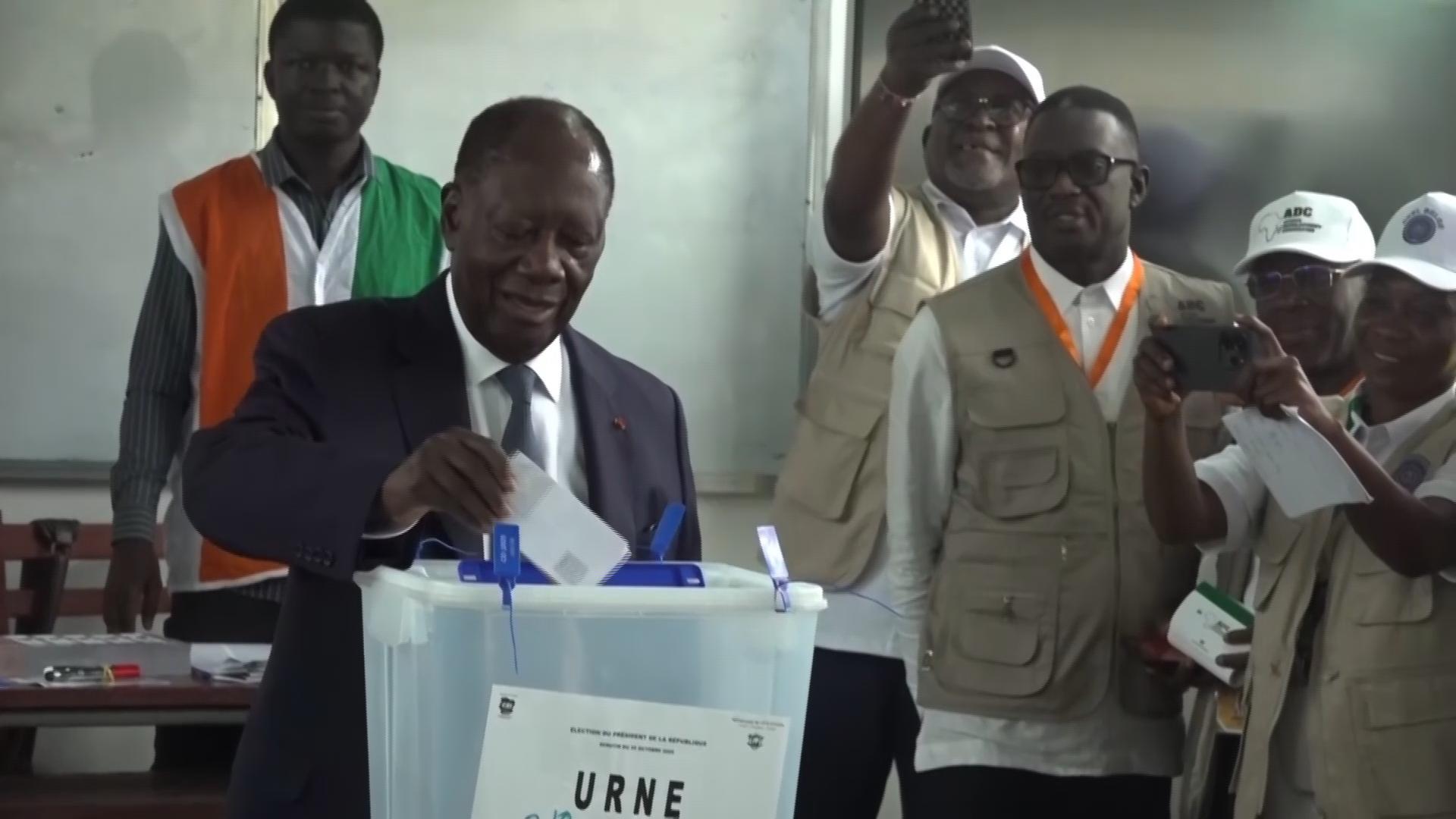 Voters, including President Alassane Ouattara, head to the polls in Ivory Coast presidential election