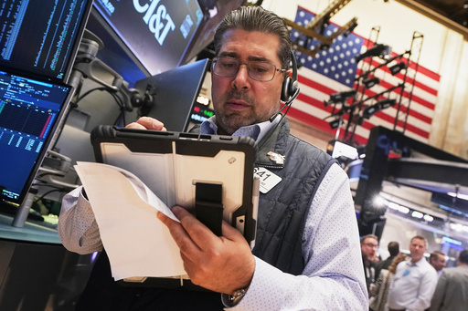 Wall Street hovers near records as corporate earnings season kicks into high gear