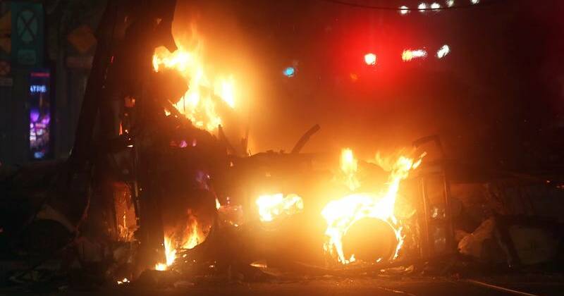 Six arrests after protesters burn police van in Dublin