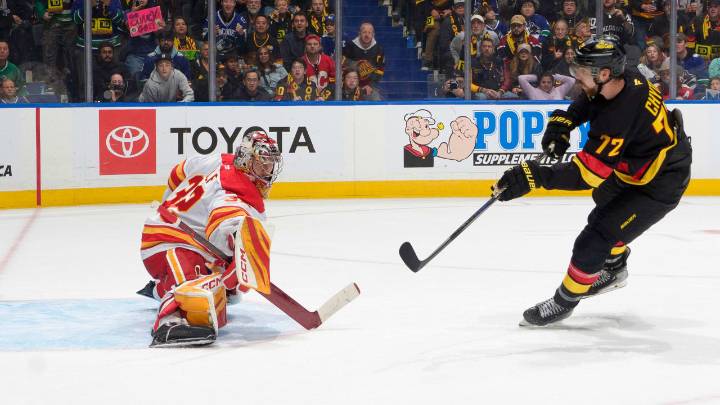 Canucks score 4 in 3rd, defeat Flames in Foote’s coaching debut