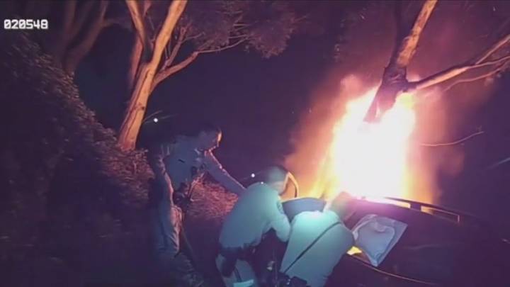 VIDEO: CHP officers rescue unconscious man from burning car   