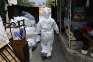 In the fire zones, an immigrant workforce warily carries out cleanups