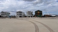 See excavator move sand only feet away from water, homes…