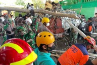 Indonesian rescuers search for missing  students after school collapse kills 37