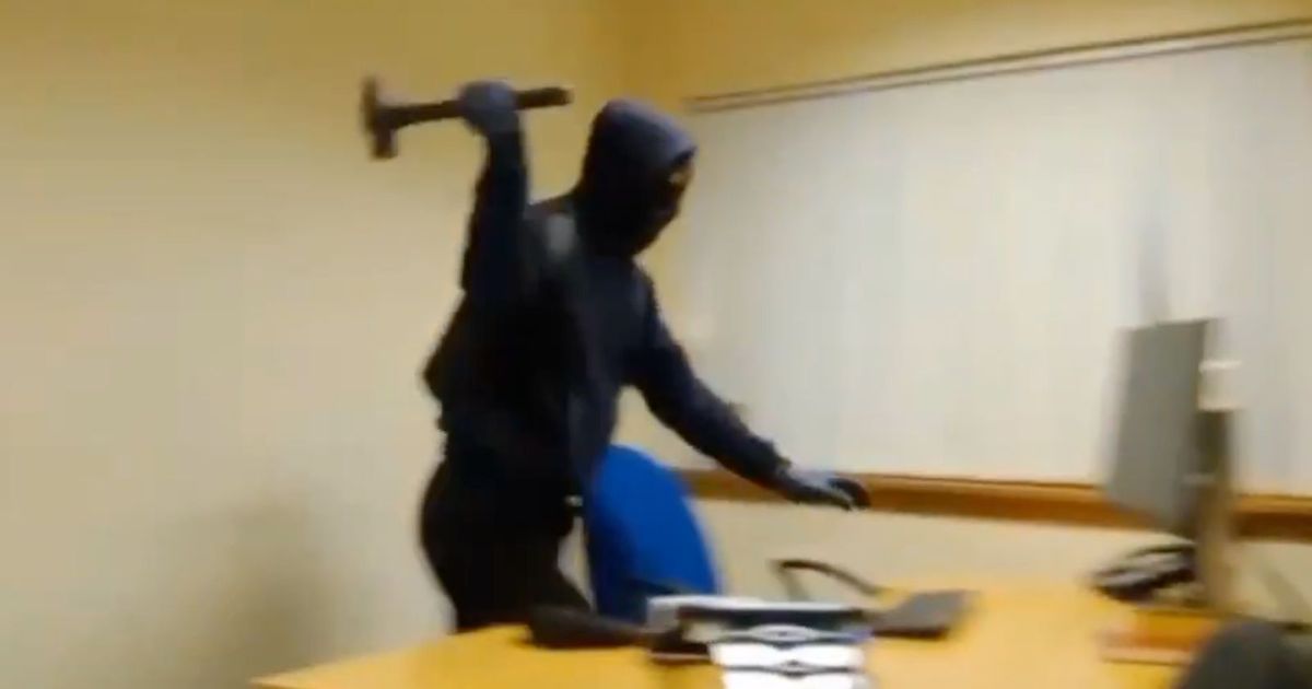Moment masked Edinburgh man rampages through office armed with a hammer