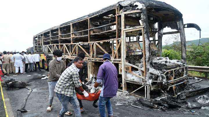 Bus catches fire after being hit by a motorcycle in southern India, killing at least 25