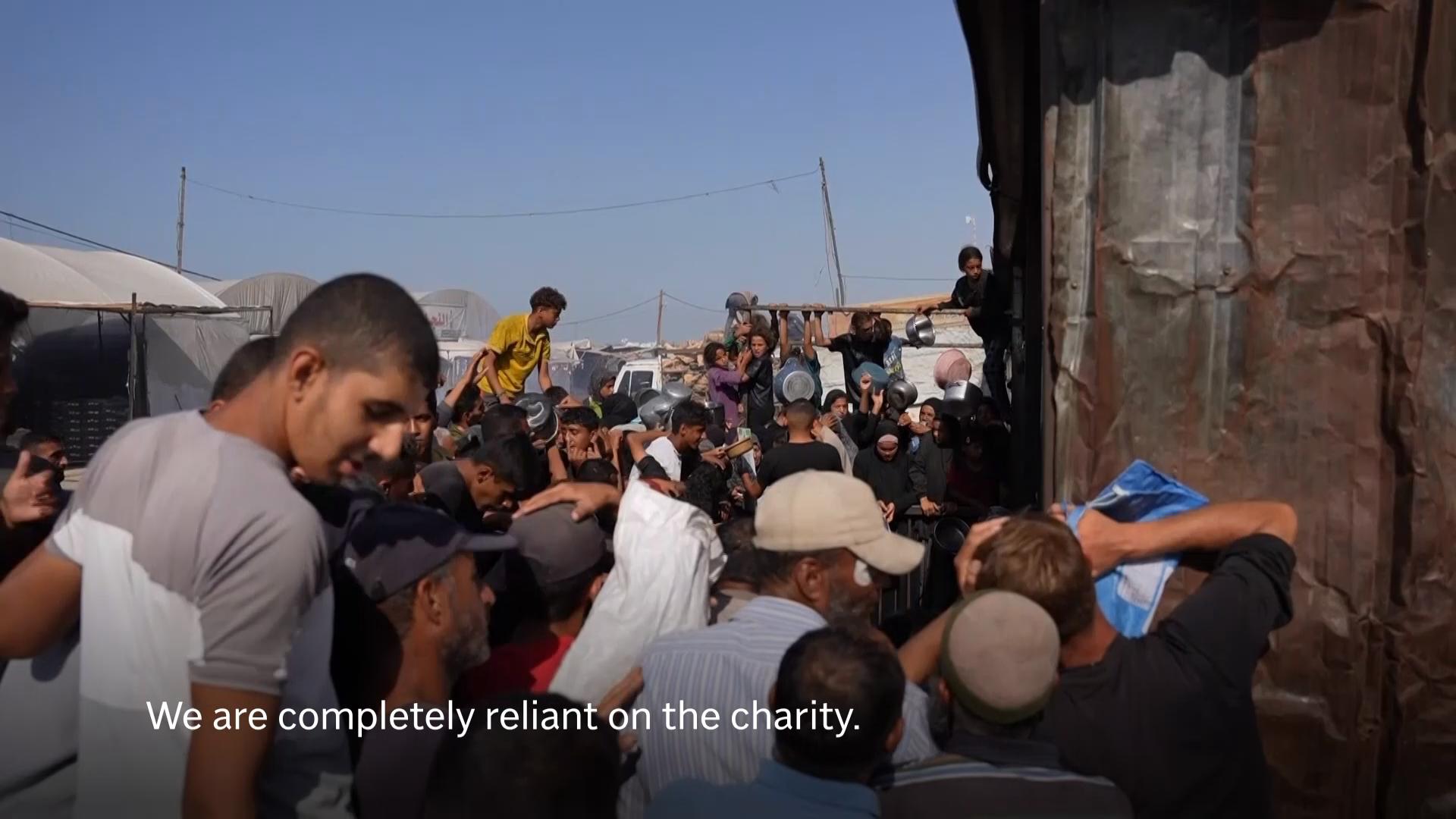 Children and women among desperate Palestinians jostling for best position in food aid queue